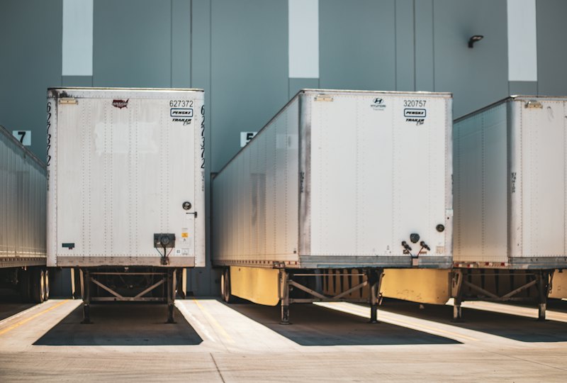 Dry van trailers backed into warehouse loading docks